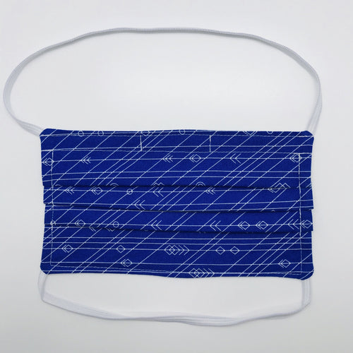 Masks are made of 2 layers 100% quilting cotton featuring a white arrows, lines and circles on cobalt blue print, behind the head elastic band and a bendable aluminum nose. Wash in washing machine and dry in dryer after each use. 7” H x 7.5” W