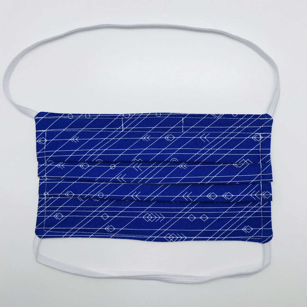 Masks are made of 2 layers 100% quilting cotton featuring a white arrows, lines and circles on cobalt blue print, behind the head elastic band and a bendable aluminum nose. Wash in washing machine and dry in dryer after each use. 7” H x 7.5” W