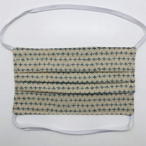 Masks are made of 2 layers 100% quilting cotton featuring a rows of blue airplanes on tan background print, over the head elastic loops and a bendable aluminum nose. Wash in washing machine and dry in dryer after each use. 7” H x 7.5” W 