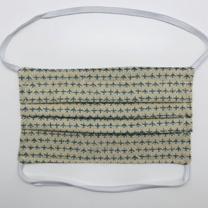 Masks are made of 2 layers 100% quilting cotton featuring a rows of blue airplanes on tan background print, over the head elastic loops and a bendable aluminum nose. Wash in washing machine and dry in dryer after each use. 7” H x 7.5” W 