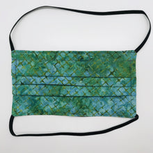 Load image into Gallery viewer, Made with three layers of blue and green batik 100% quilting cotton, this mask includes a filter pocket located in the pleats in the back of the mask for a filter of your choice, elastic head bands and a bendable aluminum nose. Machine wash and dry after each use. 7” H x 7.5” W
