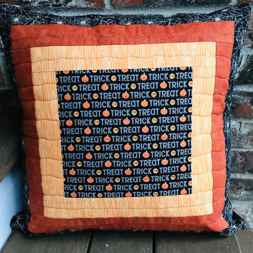 Trick or Treat pillow cover, 100% cotton with spiderwebs, pumpkins, “trick or treat” words, orange and black prints and solids. Quilted with a meandering design by machine with 40 wt Aurifil thread and has a hidden zipper in the solid black pillow back. The pillow cover only is offered and does not include the pillow form insert of 18” x 18” or 20” x 20”.  Machine wash with like colors in cold water with low suds soap such as Woolite, line dry.