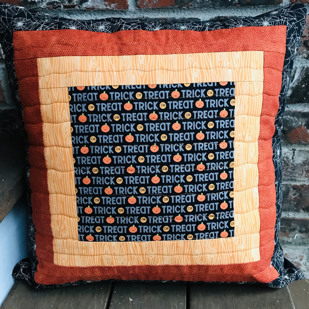 Trick or Treat pillow cover, 100% cotton with spiderwebs, pumpkins, “trick or treat” words, orange and black prints and solids. Quilted with a meandering design by machine with 40 wt Aurifil thread and has a hidden zipper in the solid black pillow back. The pillow cover only is offered and does not include the pillow form insert of 18” x 18” or 20” x 20”.  Machine wash with like colors in cold water with low suds soap such as Woolite, line dry.