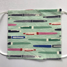 Load image into Gallery viewer, 100% quilting-weight aqua green novelty print cotton face mask with adjustable elastic ear loops and bendable nose piece. Washable, reusable fabric face mask. Wash in washing machine and dry in dryer after each use. 7” H x 7.5” W  Fabric Collection - Cotton + Steel - Trinket Pens Aqua
