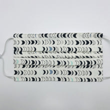 Load image into Gallery viewer, Masks are made of 2 layers 100% quilting cotton featuring blue, white and black half moons in rows on white print, adjustable elastic ear loops and a bendable aluminum nose. Wash in washing machine and dry in dryer after each use. 7” H x 7.5” W
