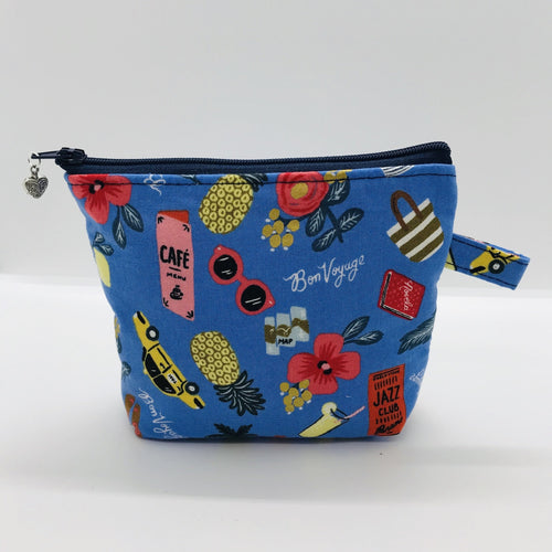 The small pouch is made from 100% blue travel themed print and has a layer of fleece for structure and a cute metal tassel. The pouch design is from the Becca Bags pattern from Lazy Girl Design. 6”W x 4.5” H x 1”D. Machine washable and dryer safe or air dry.