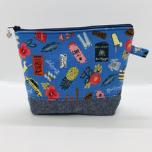 Load image into Gallery viewer, The pouch is made from 100% quilting cotton with a blue travel themed print, Kaufman Essex cotton/linen for the base, and a layer of fleece. The cute metal tassel gives an added touch. 7.5 W x 6”H x 2.5”D. Machine washable and dryer safe, or air dry.
