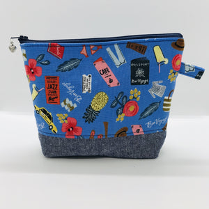 The pouch is made from 100% quilting cotton with a blue travel themed print, Kaufman Essex cotton/linen for the base, and a layer of fleece. The cute metal tassel gives an added touch. 7.5 W x 6”H x 2.5”D. Machine washable and dryer safe, or air dry.