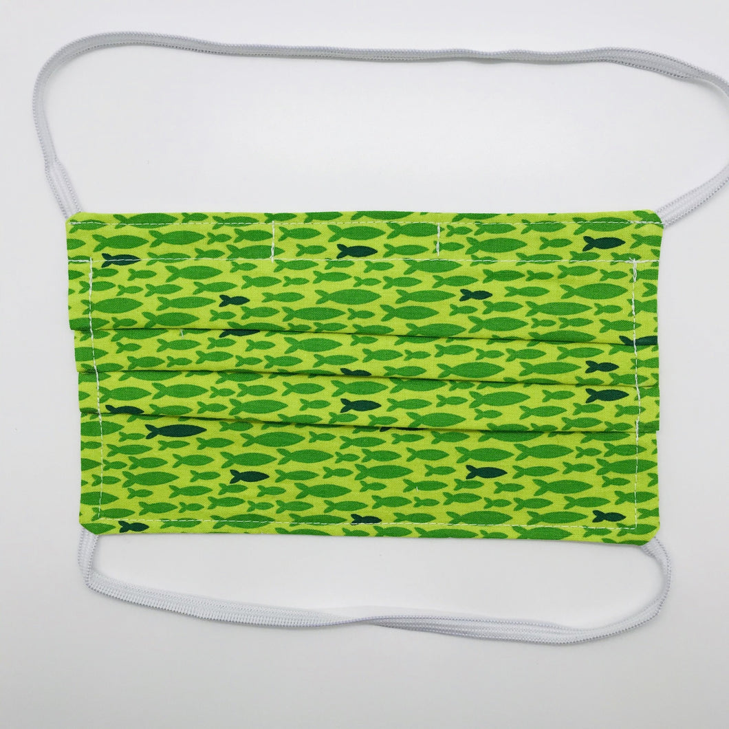 Masks are made of 2 layers 100% quilting cotton featuring a print of lime green fish in a row, over the head elastic loops and a bendable aluminum nose. Wash in washing machine and dry in dryer after each use. 7” H x 7.5” W 