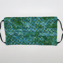 Load image into Gallery viewer, Made with three layers blue and green batik 100% quilting cotton, this mask includes a filter pocket located in the pleats in the back of the mask for a filter of your choice, adjustable elastic ear loops and a bendable aluminum nose. Machine wash and dry after each use. 7” H x 7.5” W
