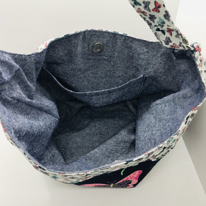 Light weight and roomy this tote is made of soft and smooth Art Gallery butterfly print cotton, and lined with Essex cotton/linen from Robert Kaufman. The inner compartment has a magnetic snap and inner pocket. 15.5” W & 14”H Total length with strap 33"