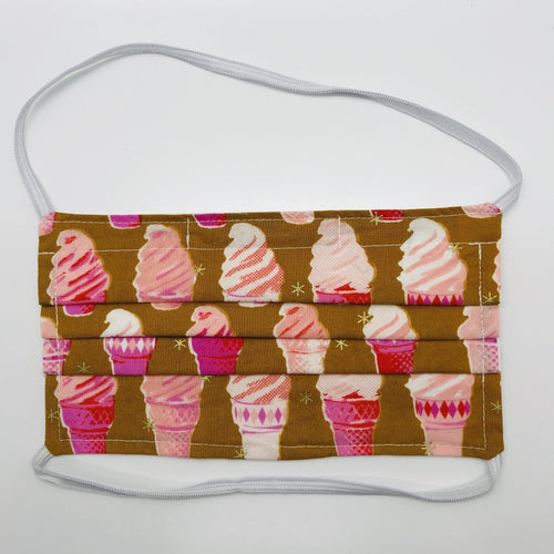 Masks are made of 2 layers of pink ice cream cones on tan print 100% quilting cotton and have behind the head elastic bands. The masks also have a bendable aluminum nose. Wash in washing machine and dry in dryer after each use. 7” H x 7.5” W