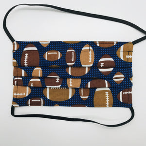 Made with three layers footballs on blue print 100% quilting cotton, this mask includes a filter pocket located in the pleats in the back of the mask for a filter of your choice, elastic head bands and a bendable aluminum nose. Machine wash and dry after each use. 7” H x 7.5” W