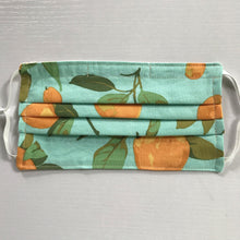 Load image into Gallery viewer, Masks are made of 2 layers of peaches on a blue/green background print 100% quilting-weight cotton, elastic adjustable ear loops and a bendable aluminum nose piece. Machine wash and dry after each use. 7” H x 7.5” W
