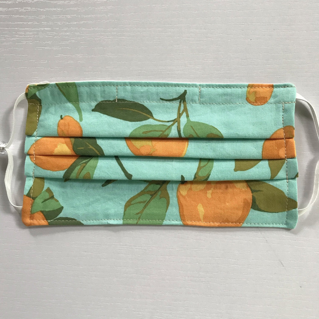 Masks are made of 2 layers of peaches on a blue/green background print 100% quilting-weight cotton, elastic adjustable ear loops and a bendable aluminum nose piece. Machine wash and dry after each use. 7” H x 7.5” W