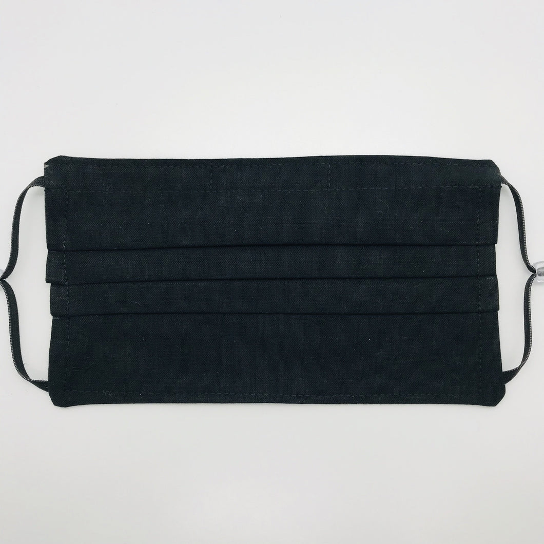 The masks are made of three layers of 100% quilting-weigh cotton fabric with a solid black front piece. This mask includes a filter pocket located in the pleats in the back of the mask for a filter of your choice and has adjustable elastic ear loops and a bendable aluminum nose piece. Machine wash and dry after each use. 7” H x 7.5” W