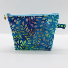 Load image into Gallery viewer, The pouch is made of 100% batik quilting cotton of blue, purple and green leaves and a layer of fleece for stability. The cute metal tassel gives an added touch. 6”W x 4.5” H x 1”D. Machine washable and dryer safe, or air dry.
