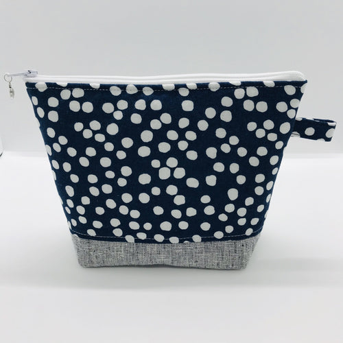 The pouch is made from 100% quilting cotton with a white dots on blue print, Kaufman Essex cotton/linen for the base, and a layer of fleece. The cute metal tassel gives an added touch. 7.5 W x 6”H x 2.5”D. Machine washable and dryer safe, or air dry.