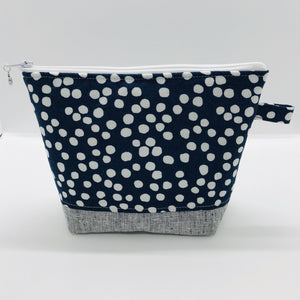 The pouch is made from 100% quilting cotton with a white dots on blue print, Kaufman Essex cotton/linen for the base, and a layer of fleece. The cute metal tassel gives an added touch. 7.5 W x 6”H x 2.5”D. Machine washable and dryer safe, or air dry.