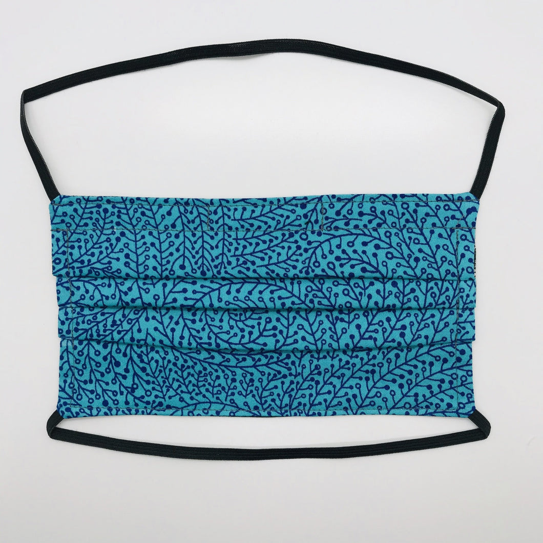 Masks are made of 2 layers 100% quilting cotton featuring a black vines on blue print, over the head elastic loops and a bendable aluminum nose. Wash in washing machine and dry in dryer after each use. 7” H x 7.5” W 