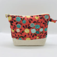 Load image into Gallery viewer, The pouch is made from flowers on orange quilting cotton, an inner layer of fleece, essex/linen for the base and a cute metal tassel. The pouch design is from the Becca Bags pattern from Lazy Girl Design. Machine washable and dryable or air dry. 7.5W x 6”H x 2.5”D
