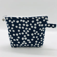 Load image into Gallery viewer, The pouch is made of 100% quilting cotton of a white dots on blue print and a layer of fleece for stability. The cute metal tassel gives an added touch. 6”W x 4.5” H x 1”D. Machine washable and dryer safe, or air dry.
