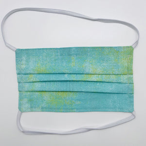 Made with three layers a green, white and yellow textured print 100% quilting cotton, this mask includes a filter pocket located in the pleats in the back of the mask for a filter of your choice, over the head elastic loops and a bendable aluminum nose. Machine wash and dry after each use. 7” H x 7.5” W