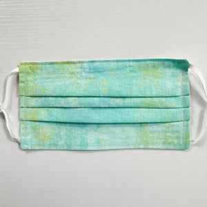 Made with three layers green, white and yellow textured colored print 100% quilting cotton, this mask includes a filter pocket located in the pleats in the back of the mask for a filter of your choice, adjustable elastic ear loops and a bendable aluminum nose. Machine wash and dry after each use. 7” H x 7.5” W