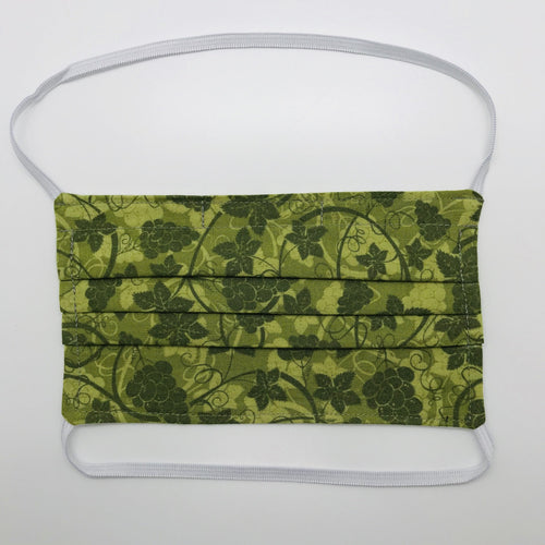 Masks are made of 2 layers 100% quilting cotton featuring a olive green grape leaves print, over the head elastic loops and a bendable aluminum nose. Wash in washing machine and dry in dryer after each use. 7” H x 7.5” W 