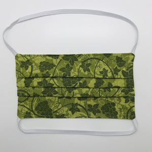 Masks are made of 2 layers 100% quilting cotton featuring a olive green grape leaves print, over the head elastic loops and a bendable aluminum nose. Wash in washing machine and dry in dryer after each use. 7” H x 7.5” W 