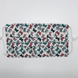 Masks are made of 2 layers of 100% quilting cotton and feature a butterfly print by Art Gallery Fabrics. The mask has elastic adjustable ear loops and a bendable aluminum nose piece.  Machine wash and dry after each use. 7” H x 7.5” W