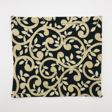 Load image into Gallery viewer, Image of gold swirls on black fabric
