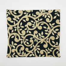 Load image into Gallery viewer, Image of gold swirls on black fabric

