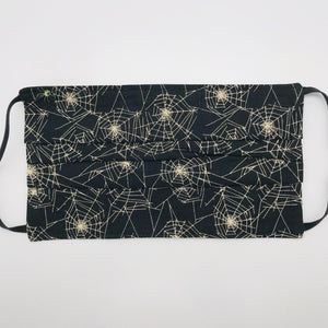 Masks are made of 2 layers 100% quilting cotton featuring a print of spider webs on black, adjustable elastic ear loops and a bendable aluminum nose. Wash in washing machine and dry in dryer after each use. 7” H x 7.5” W