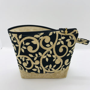 The pouch is made from 100% quilting cotton with a gold swirls on black print, Kaufman Essex cotton/linen for the base, and a layer of fleece. The cute metal tassel gives an added touch. 7.5 W x 6”H x 2.5”D. Machine washable and dryer safe, or air dry.