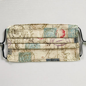 Made with three layers of antique stamps on tan print 100% quilting cotton, this mask includes a filter pocket located in the pleats in the back of the mask for a filter of your choice, adjustable elastic ear loops and a bendable aluminum nose. Machine wash and dry after each use. 7” H x 7.5” W