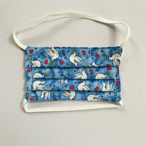 100% quilting-weight cotton blue with white doves print kids fabric face mask with elastic bands. Washable, reusable fabric face mask. Wash in washing machine and dry in dryer after each use. 5.5”W x 5.5” H  Ages 2-8, not recommended for children under the age of 2.