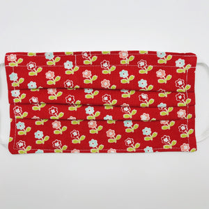 Masks are made of 2 layers of 100% quilting-weight cotton fabric with a vintage picnic flowers on red print. The elastic adjustable ear loops tightened with a craft bead to make them comfortable to fit a wider range of sizes. The masks also have a bendable aluminum nose piece. Machine wash and dry after each use.     7” H x 7.5” W