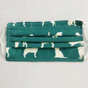 Made with three layers of white dogs on green black print 100% quilting cotton, this mask includes a filter pocket located in the pleats in the back of the mask for a filter of your choice, adjustable elastic ear loops and a bendable aluminum nose. Machine wash and dry after each use. 7” H x 7.5” W