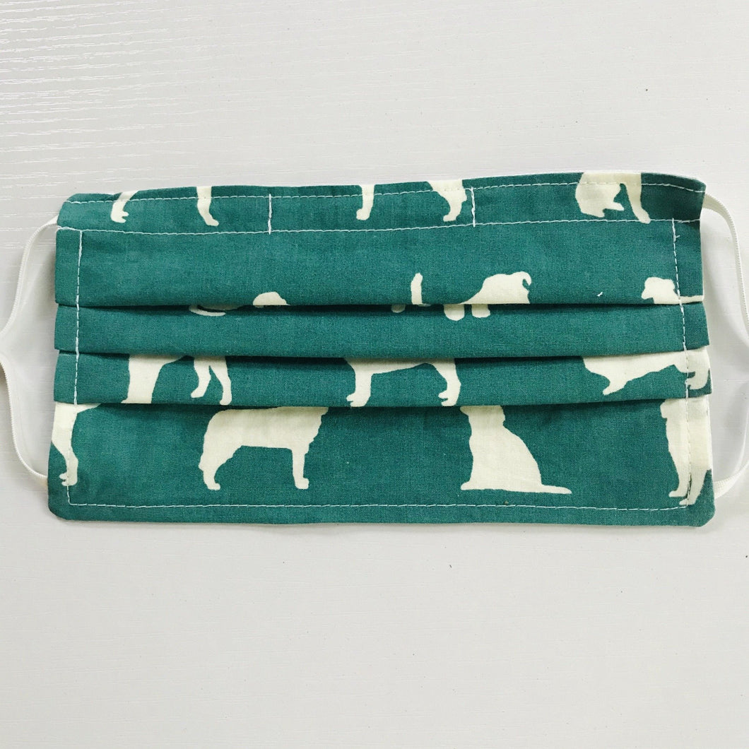 Made with three layers of white dogs on green black print 100% quilting cotton, this mask includes a filter pocket located in the pleats in the back of the mask for a filter of your choice, adjustable elastic ear loops and a bendable aluminum nose. Machine wash and dry after each use. 7” H x 7.5” W
