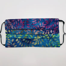 Load image into Gallery viewer, Masks are made of 2 layers of 100% quilting-weight batik cotton of blue, green and purples leaves. The masks have elastic adjustable ear loops and a bendable aluminum nose piece. Machine wash and dry after each use. 7” H x 7.5” W
