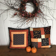 Load image into Gallery viewer, Trick or Treat pillow cover, 100% cotton with spiderwebs, pumpkins, “trick or treat” words, orange and black prints and solids. Quilted with a meandering design by machine with 40 wt Aurifil thread and has a hidden zipper in the solid black pillow back. The pillow cover only is offered and does not include the pillow form insert of 18” x 18” or 20” x 20”.  Machine wash with like colors in cold water with low suds soap such as Woolite, line dry.
