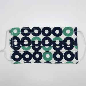 Made with three layers of 100% blue, green and white record shapes print cotton fabric, filter pocket located in the pleats in the back of the mask, adjustable elastic ear loops and a bendable aluminum nose piece. 7” H x 7.5” W